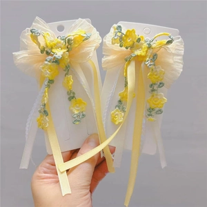 Floral embroidered hair clip with yellow ribbon bow for girls on display card