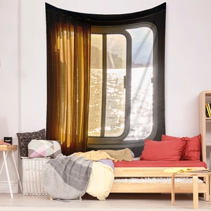 Detail of bohemian tapestry featuring a sunlit window view and lakeside scenery