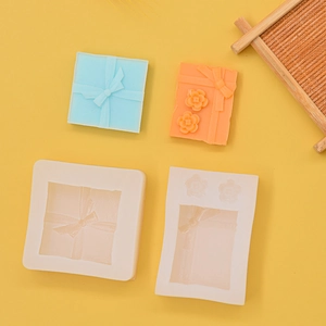 Detail of 3D gift box silicone molds showing bow textures for DIY soap and candle making