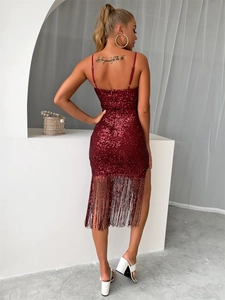 Detailed view of the red sequined dress featuring elegant fringe trim on the hemline
