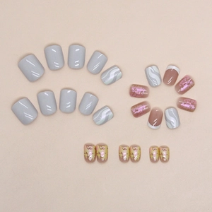 Short square press-on nails featuring aurora ripple textures and marble solid color designs