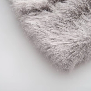 Close-up of premium long-pile grey faux fur fabric texture showing soft plush material