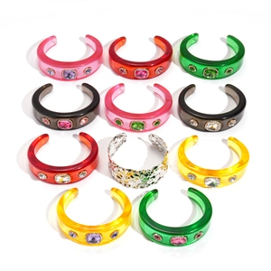 Colorful resin geometric bangles with inset rhinestones on a clean white background