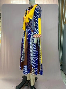 Detail of printed maxi dress showing bow-tie collar and mixed geometric patterns