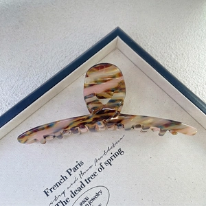 Close-up of a 13.5cm large tortoiseshell hair claw clip with colorful resin textures