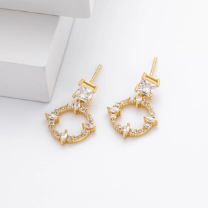 Detail shot of gold-plated S925 silver earrings with zircon stones on a white background