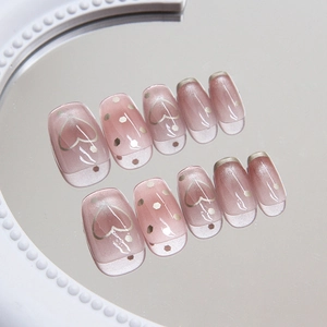 Cat eye press-on nails with pink heart patterns and shimmering silver glitter accents