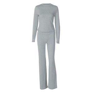 Flat lay of a grey ribbed knit loungewear set with crewneck top and flared trousers