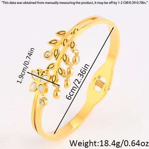 Detail view of gold butterfly and leaf bangle with white shell inlay and measurements