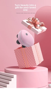 Pink electric head massager with silicone heads popping out of a dotted gift box