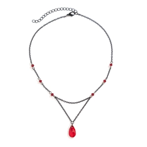 Detail of gothic choker featuring a red teardrop crystal pendant on a black metal chain