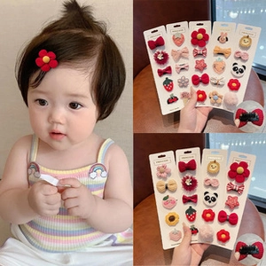 Detail of cute assorted cartoon hair clips set with fabric bows and animal designs