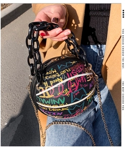 Close-up of basketball shape crossbody bag with street graffiti and acrylic chain strap
