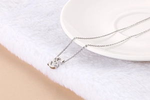 Detail of silver chain necklace with crystal-inlaid capital letter S pendant
