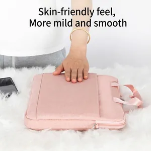 Pink waterproof laptop shoulder bag with reinforced handle and external storage pocket