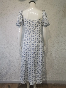 Rear view of puff sleeve floral midi dress with intricate blue flower print details