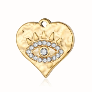 Detailed view of heart-shaped evil eye pendant with hammered gold texture and sparkling zircon