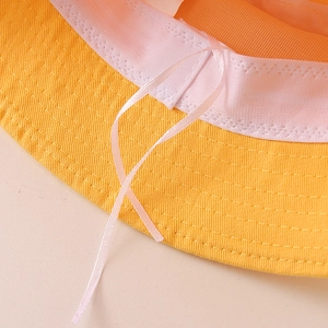 Interior view of yellow cotton sun hat with pink adjustable ribbon and sweatband