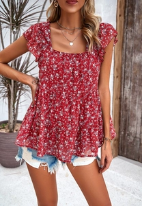 Detail view of red floral sleeveless top with square neck and ruffled hem for summer