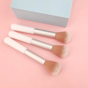 Detail of soft synthetic fiber bristles on portable white makeup blush brushes