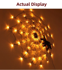 Detail of warm LED spider web lights with a black fuzzy spider for Halloween decor