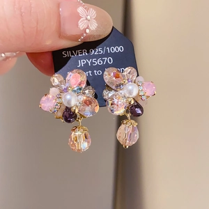 Detail of 925 silver flower earrings with pink crystal petals and dangling beads