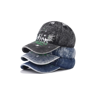 Distressed denim baseball caps with vintage graffiti and paint splatter street style