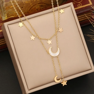 Elegant gold double-layered necklace featuring star and crescent moon pendants on display