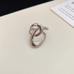 Macro view of silver starfish geometric open ring with abstract irregular metal texture