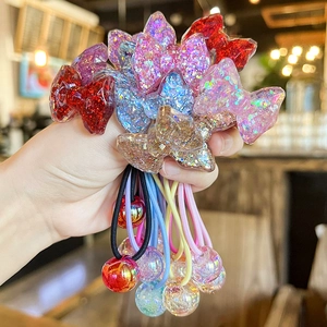 Close-up of colorful sequined bow hair ties with iridescent beads and elastic bands