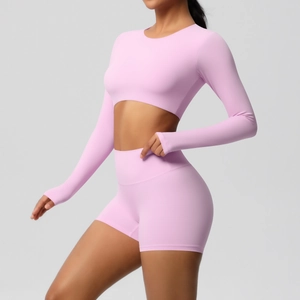 Detail view of pink long sleeve yoga top and high waist shorts set for women