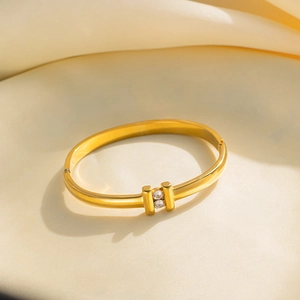 Minimalist gold-plated stainless steel bracelet featuring double bars and white zircons