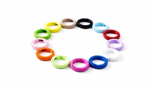 Close-up of assorted colorful metal spring rings for DIY keychains in a circular layout