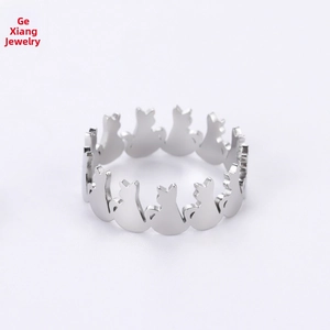 Close-up of cat silhouette patterns on the silver stainless steel open ring