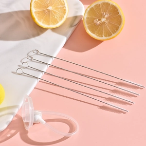Five 304 stainless steel straw cleaning brushes with white bristles on pink background