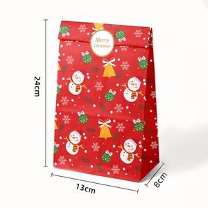 Detail of Christmas paper gift bag with snowman design and 24x13x8 cm dimensions