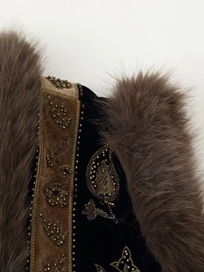 Detail of beaded embroidery on black velvet with brown faux fur trim for luxury vest