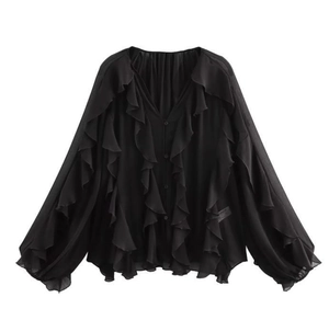 Detailed view of black chiffon blouse featuring ruffled layers and a deep V-neckline