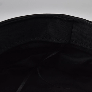 Macro detail of PU leather beret interior with adjustable drawstring and sweatband