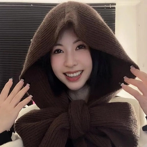 Close-up of a model wearing a dark brown knitted hooded scarf for winter warmth