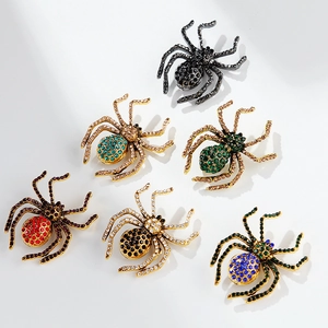 Set of six colorful vintage spider brooches with rhinestones on white background
