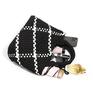 Handwoven black and white checkered tote bag showing large capacity for daily essentials