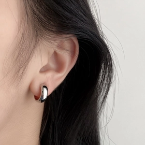 French style silver spiral hoop earring for women with polished metallic finish