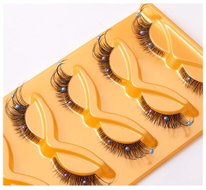 Close-up of 5 pairs of cat-eye false eyelashes with colorful pearl beads on clear band