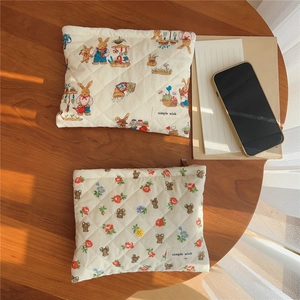 Detailed close-up of quilted cotton makeup bags with cute animal and floral prints
