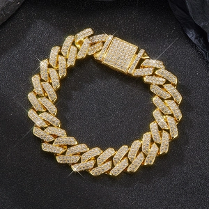 Detail of 14mm gold Cuban link necklace featuring micro-paved rhinestones on the box clasp