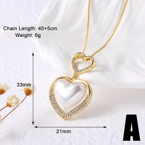 Detail view of heart pendant featuring white pearl and shimmering zircon stones on a gold chain