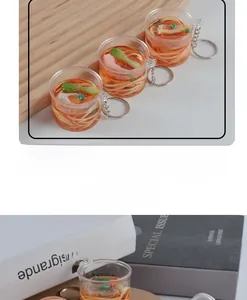 Detailed close-up of mini realistic beef noodle bowl keychain with metal ring accessory
