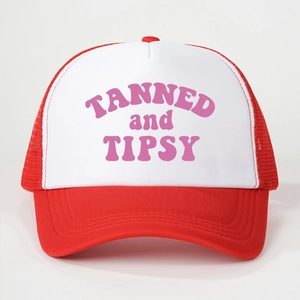 Detail of red and white mesh trucker hat with pink TANNED and TIPSY printed text