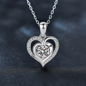 Macro shot of 925 sterling silver heart pendant with shimmering center stone and pavé setting